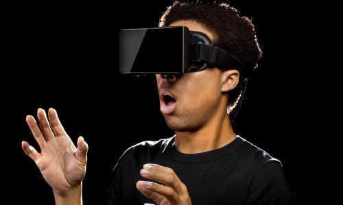 Virtual Reality headset on a black male playing video games